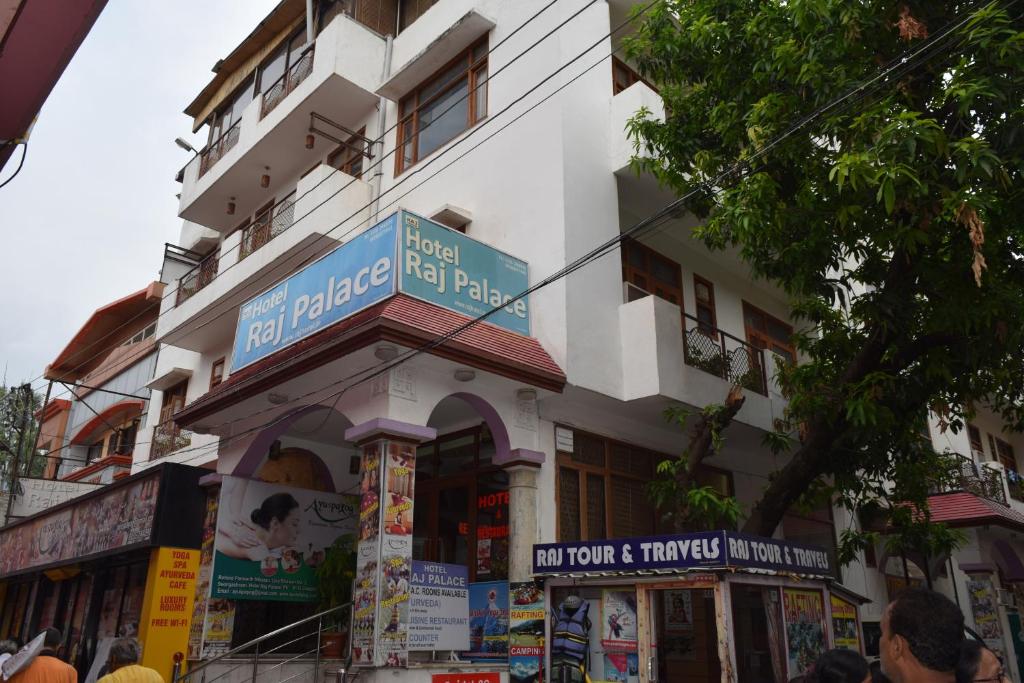 a building with a sign on the side of it at Hotel Raj Palace in Rishīkesh