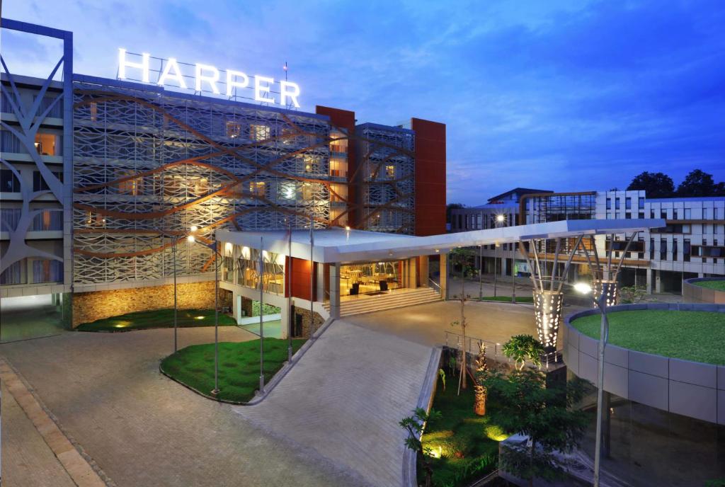 
a large building with a large clock on it at Harper Perintis by ASTON in Makassar
