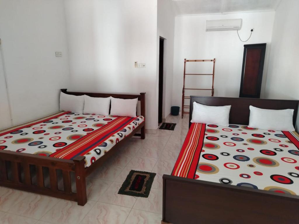 two beds sitting next to each other in a room at The Heritage Hotel in Polonnaruwa