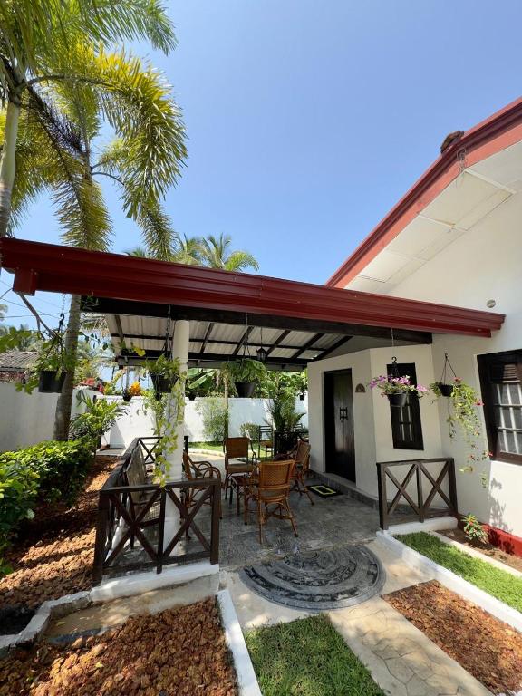 a patio with awning and a table and chairs at Villa Octopus in Maggona West