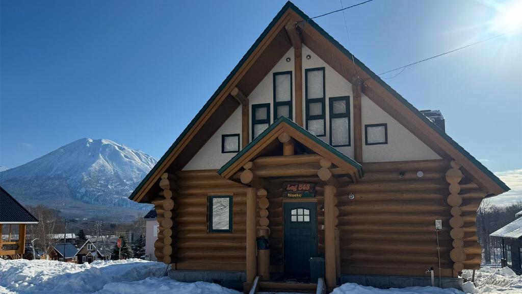 a log cabin with a mountain in the background at Log 343 by Elite Havens in Kutchan