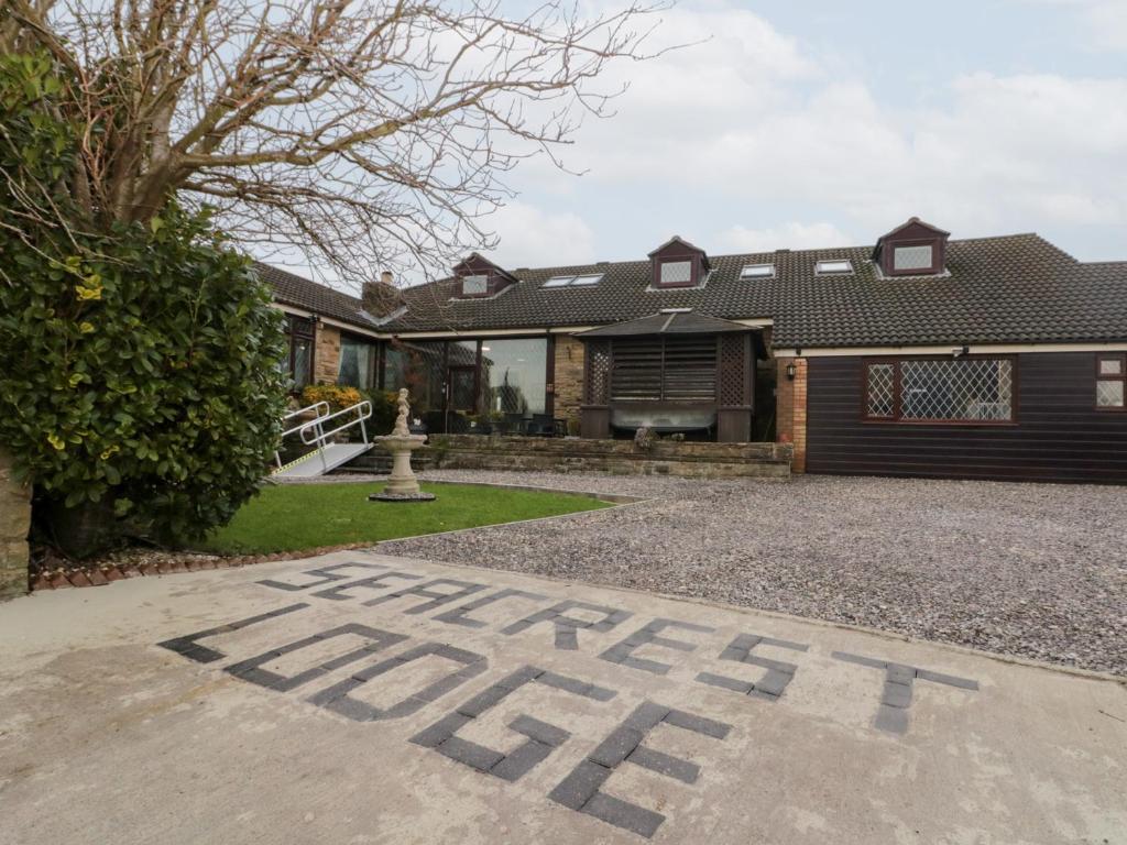 a house with the word home written on the driveway at Seacrest Lodge in Scarborough
