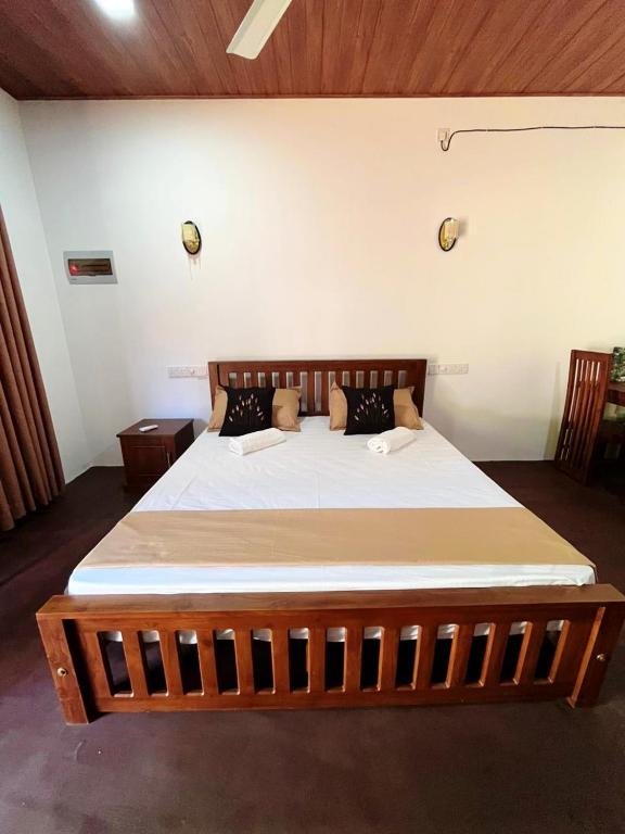 a bedroom with a large wooden bed in a room at Villa Mistica - Hiriketiya Dikwella in Dickwella
