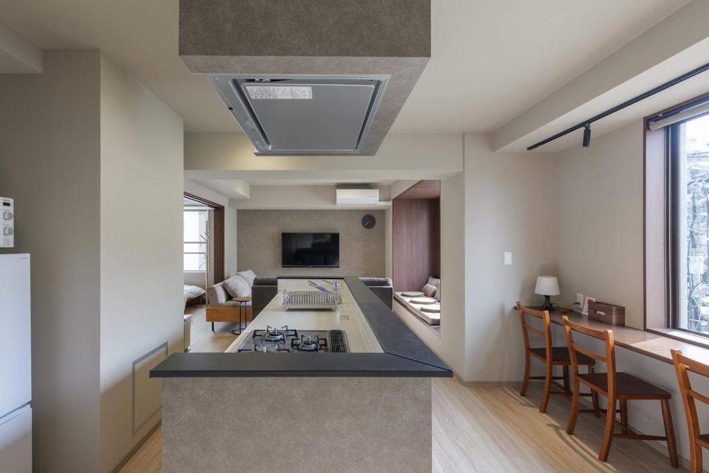 a kitchen with a stove and a counter top at A&m花畑401 in Kumamoto