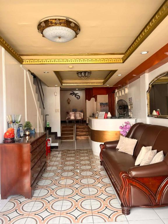 a living room with a couch and a bar at Optimun Inn in Davao City