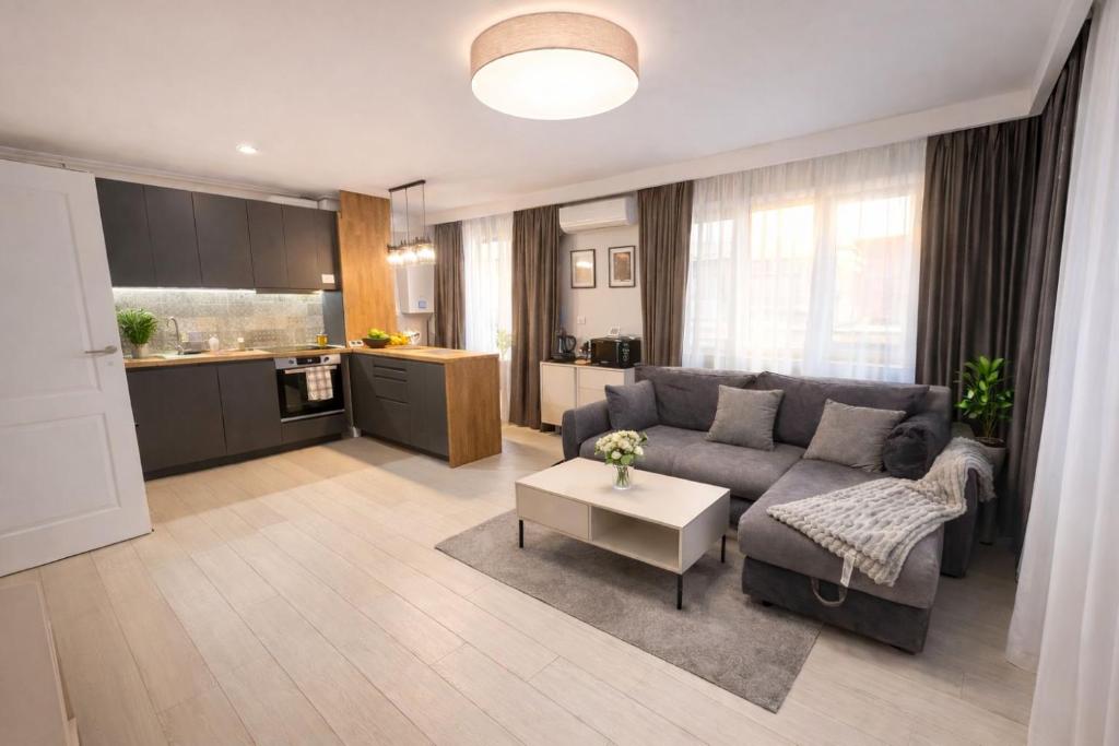 a living room with a couch and a table at Olympus City Escape in Bucharest