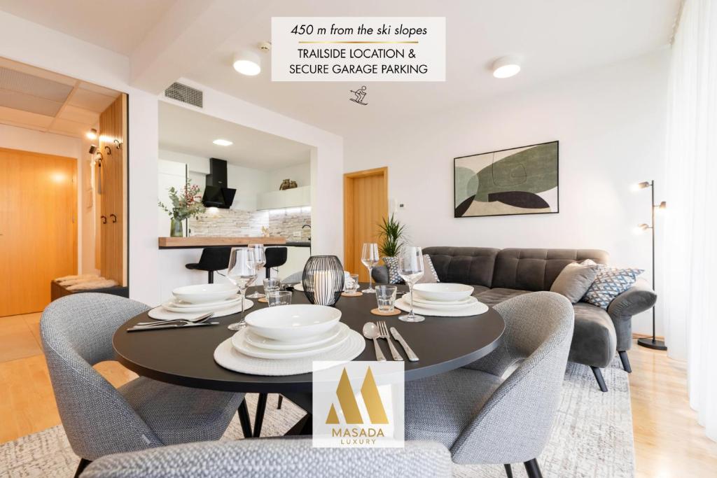 a dining room and living room with a table and chairs at Apartma Masada in Maribor