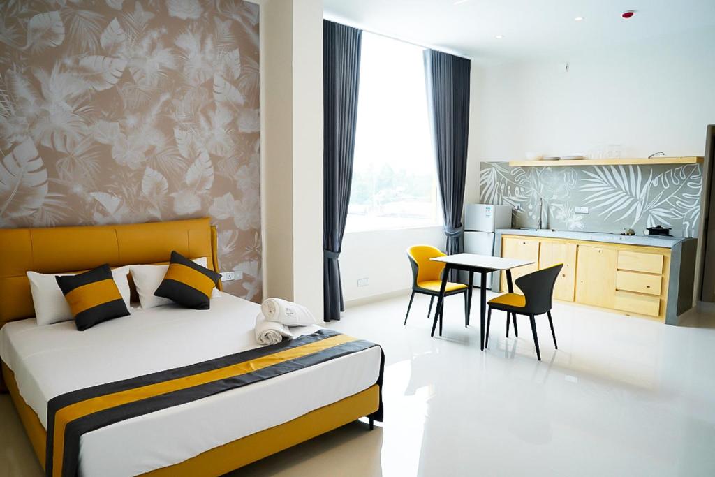 a bedroom with a bed and a table and chairs at Lotus Luxury Residencies in Negombo