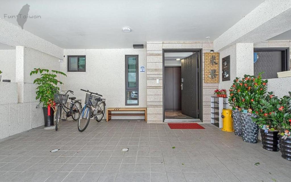 a pair of bikes parked outside of a building at Migo Homestay in Yilan City