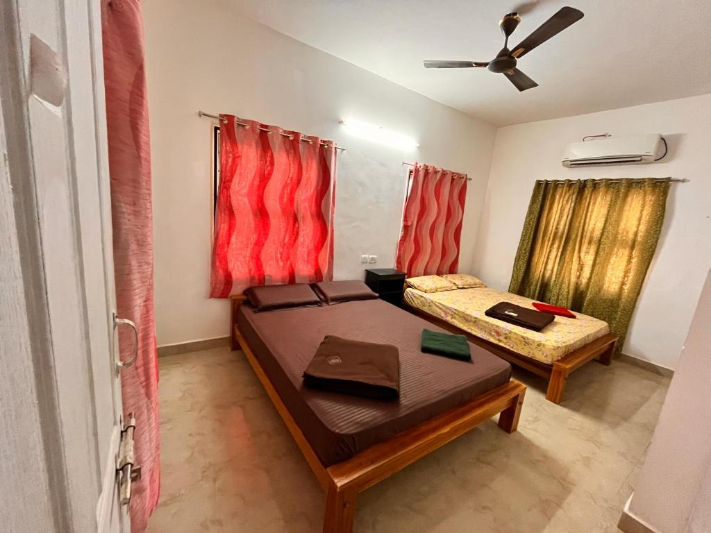 a room with a bed and a table in it at Jamath Villas 1307 in Kīlakarai