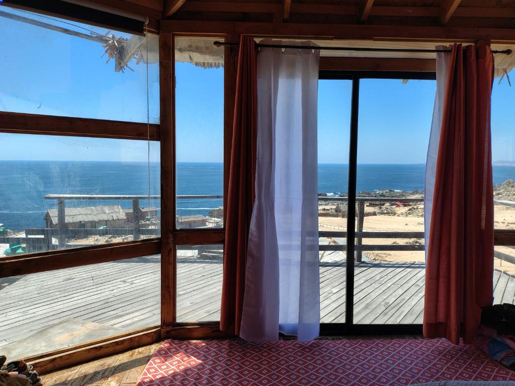 a room with a window with a view of the ocean at Casa La Virgen in Burro Muerto