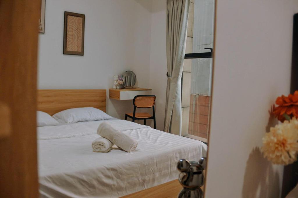 a bedroom with a bed with two towels on it at The Sun Avenue - TPHomes in Ho Chi Minh City