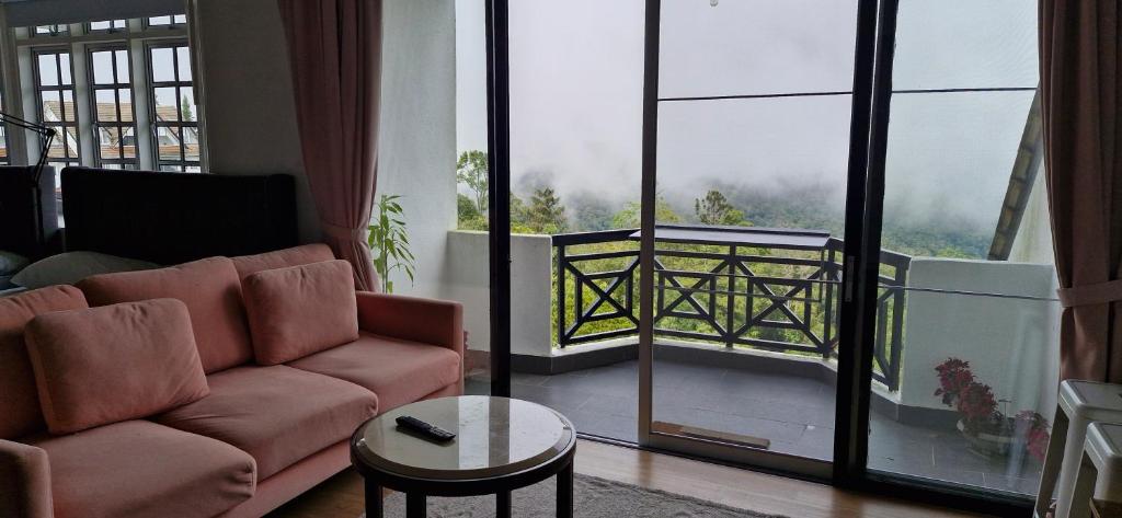 a living room with a couch and a large window at A3-6-1Silverpark LuxMountsin view Lifted unit in Bukit Fraser