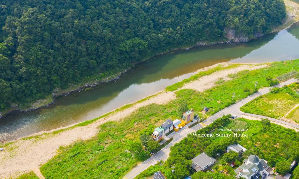 an aerial view of a river with a couple of trucks at Welcome Sunny House in Hongcheon