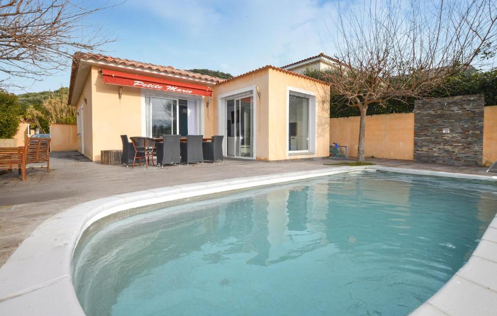 a swimming pool in front of a house at Villa Piscine Privative in Saint-Florent