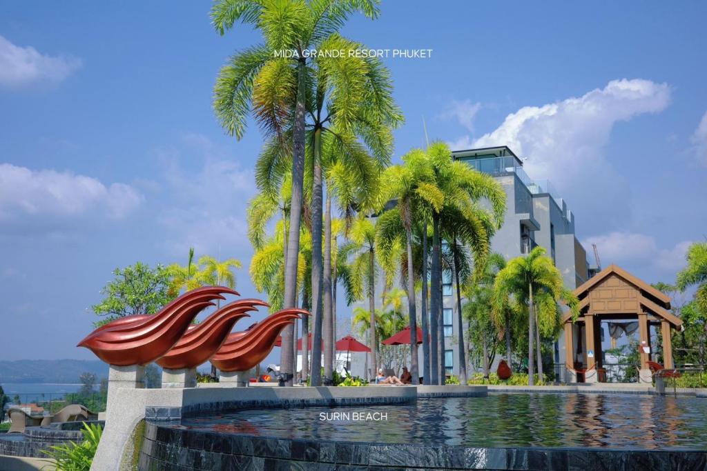 a rendering of a resort swimming pool with palm trees at Suite With Sea View By Mida Grande Resort in Surin Beach