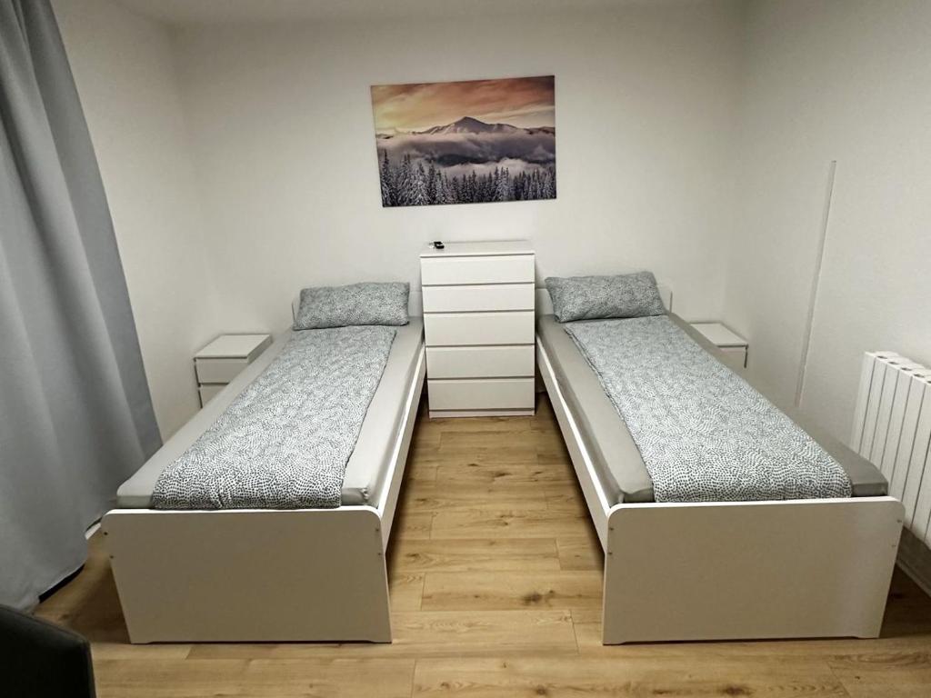 a bedroom with two beds and a painting on the wall at Apartment in Bergkamen in Bergkamen