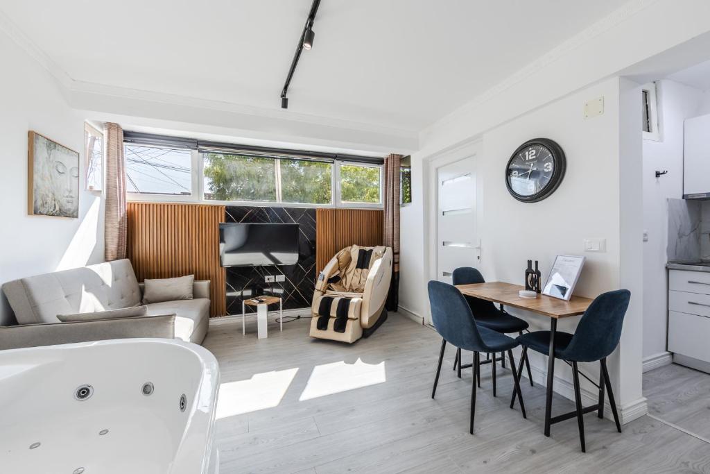 a living room with a table and chairs at Green Luxe Suite 2 by PikHost in Shkodër