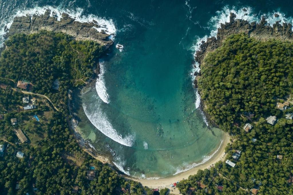 an aerial view of a beach and the ocean at W15 Hiriketiya in Dickwella