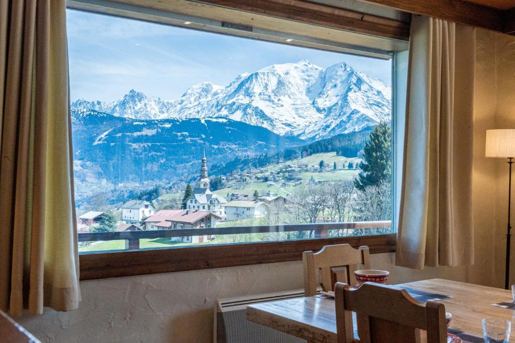a large window with a view of a mountain at Chalet Sapi in Combloux