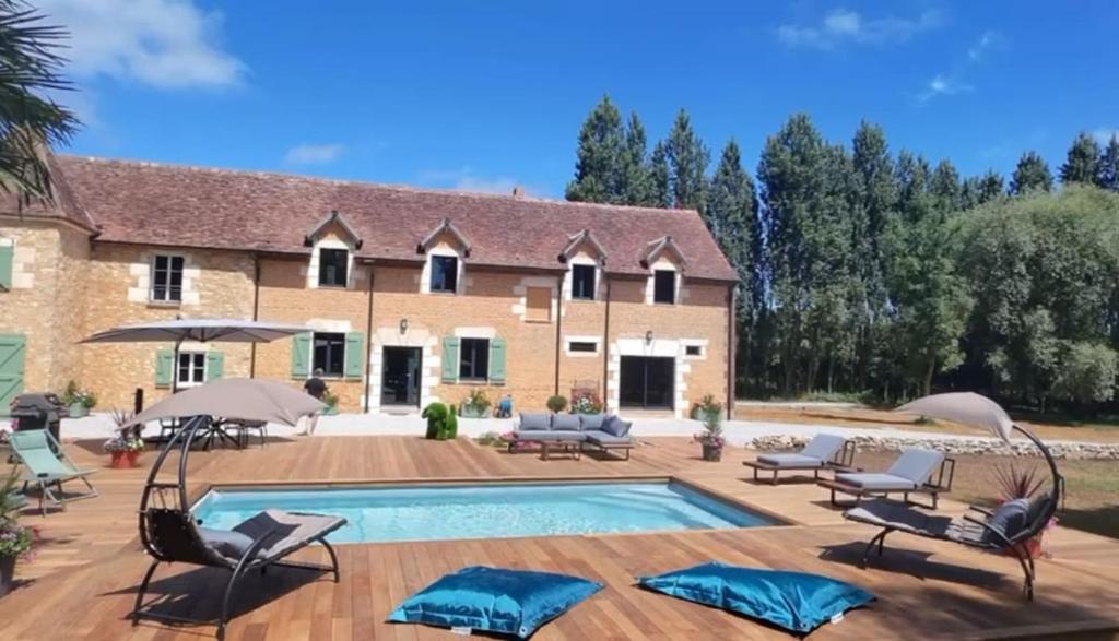 a house with a swimming pool in front of it at Le Chêne Guesthouse in Aunou-sur-Orne