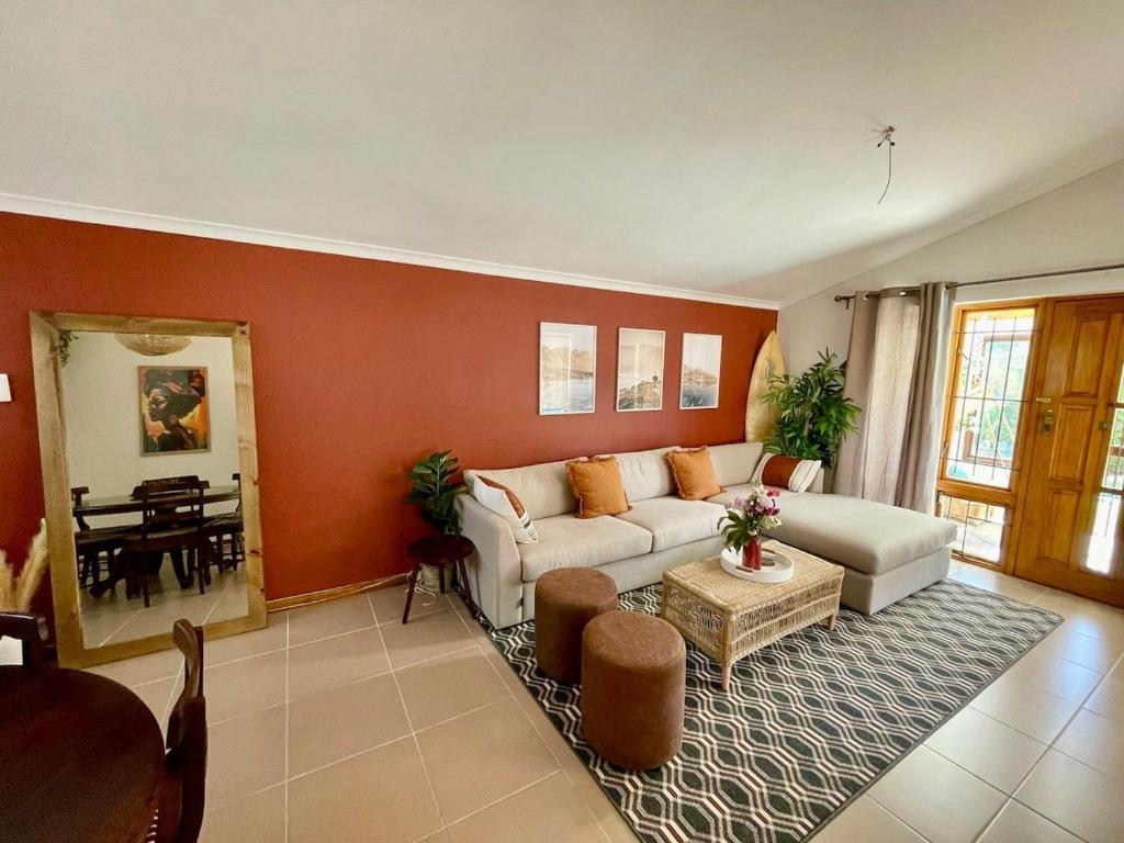 a living room with a couch and a table at Serenity in Fish Hoek