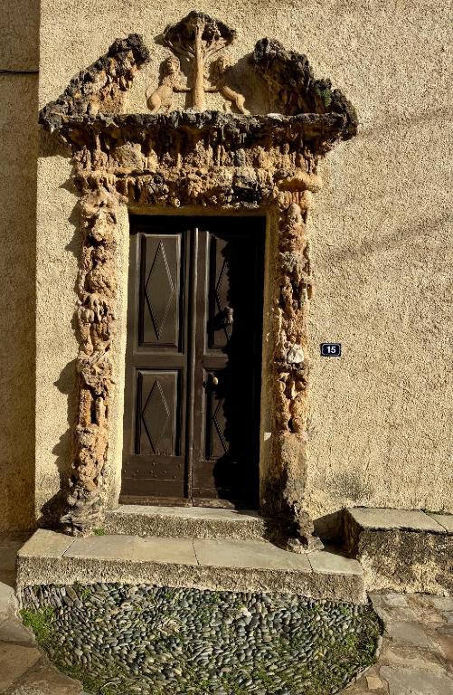 an entrance to a building with a door at Tour XIIIe siècle, vue mer, Cap Corse in Brando