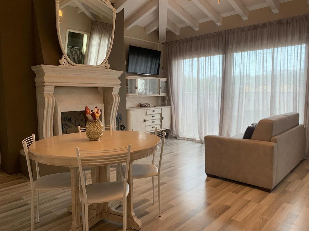 a living room with a table and a couch at Penthouse Apartment Desenzano in Desenzano del Garda