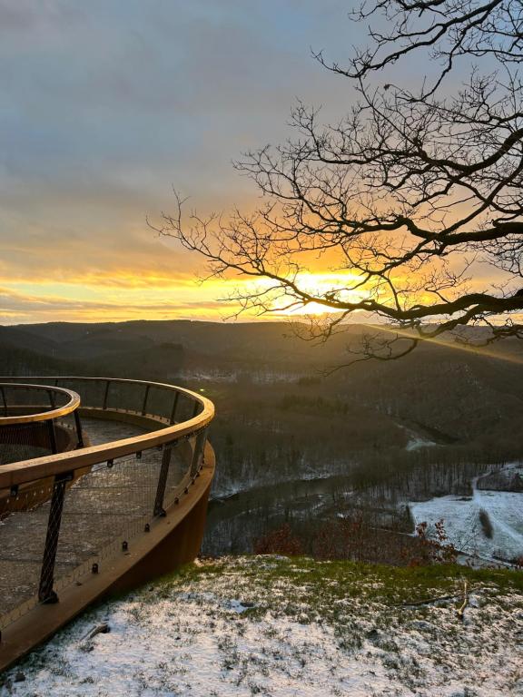 a boat sitting on top of a hill with a sunset at Semoïa Lodge in Vresse-sur-Semois