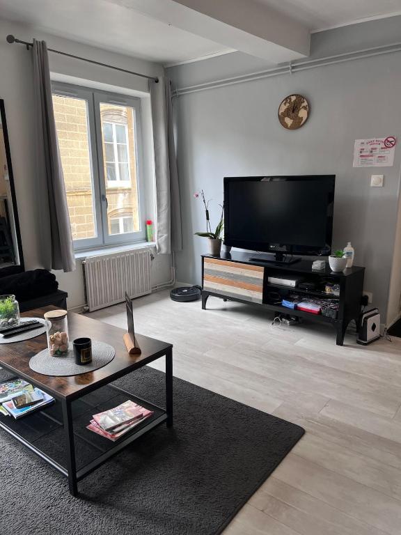 a living room with a large flat screen tv at Chez Nath House in Sedan