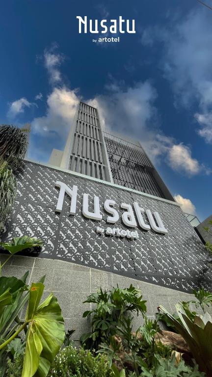 a building with a hussaru sign on the side of it at Nusatu by ARTOTEL - Semarang in Semarang