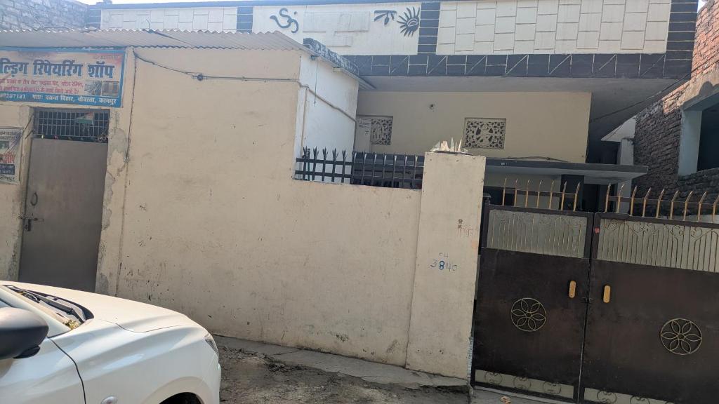 a white car parked in front of a building at Bela bhavan in Kānpur