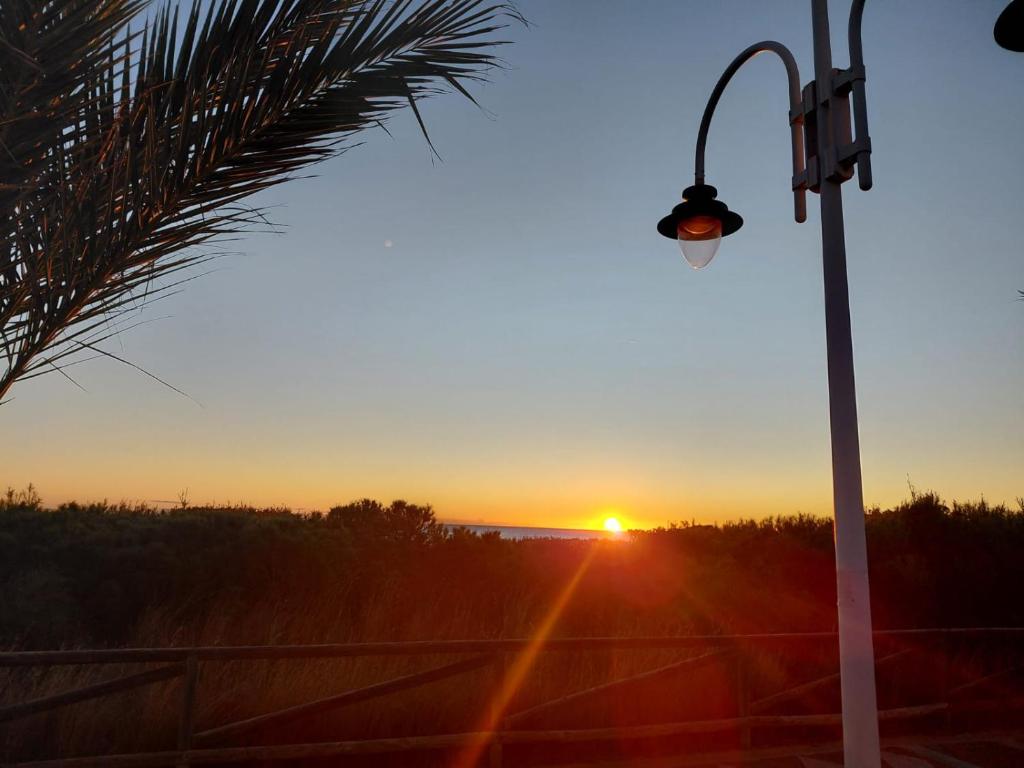 a street light with the sun setting in the background at Costa Blanca Suit in Arenales del Sol