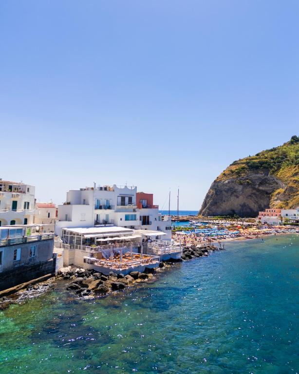 a beach with a bunch of buildings and the water at Roccobarocco Boutique Hotel in Sant'Angelo D'Ischia