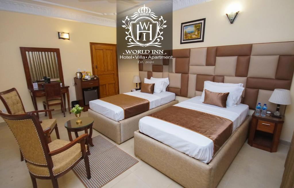 a hotel room with two beds and a chair at World Inn by WIH in Karachi