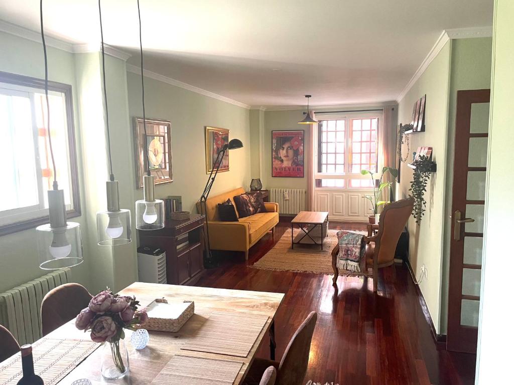 a living room with a table and a couch at Figueroa Apartments in Pontevedra
