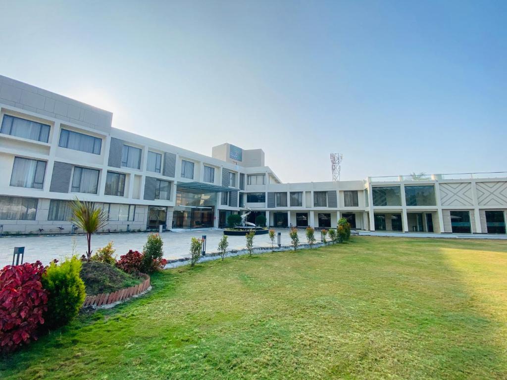 a large building with a lawn in front of it at The Manak Bagh in Sehore