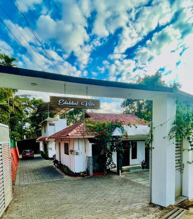 a building with a sign that reads balala villa at Edakkal Pool Villa in Ambalavayal