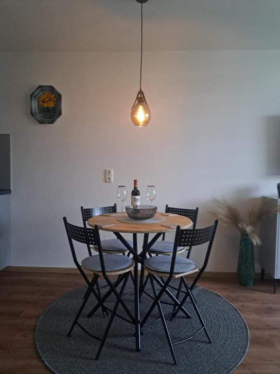 a dining room table with chairs and a pendant light at Sternenacht in Sankt Englmar