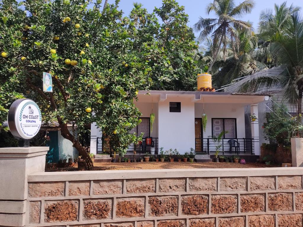 a house with a lemon tree in front of it at Om Coast Gokarna in Gokarna