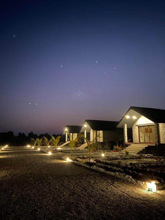 a house with lights in front of it at night at Gulab Bagh Jawai in Jawāi Bāndh