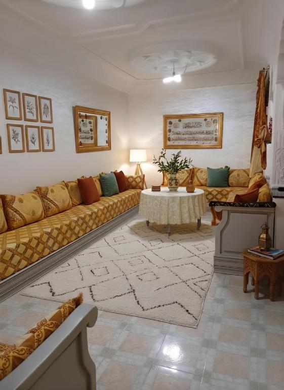 a living room with a couch and a table at Martil Beach Apartment in Martil