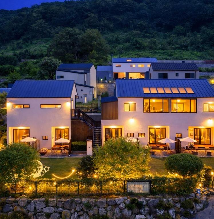 a large white house with lights in front of it at 경기도 양평군 강남로714-14 미니조식무료서비스 in Yangpyeong