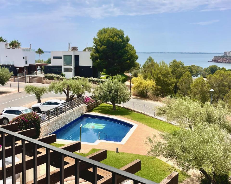 a view of a swimming pool from a balcony at Olimar, vistas al mar y relax junto a la playa in L'Ampolla