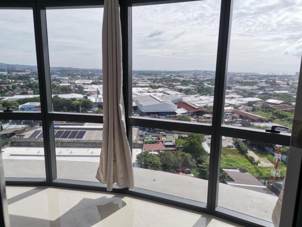a view of a city from a window at Sezuki JTower Stay in Mandaue City
