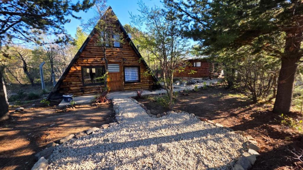 a log cabin in the woods with trees at Cabañas de montaña Triskel in Aluminé