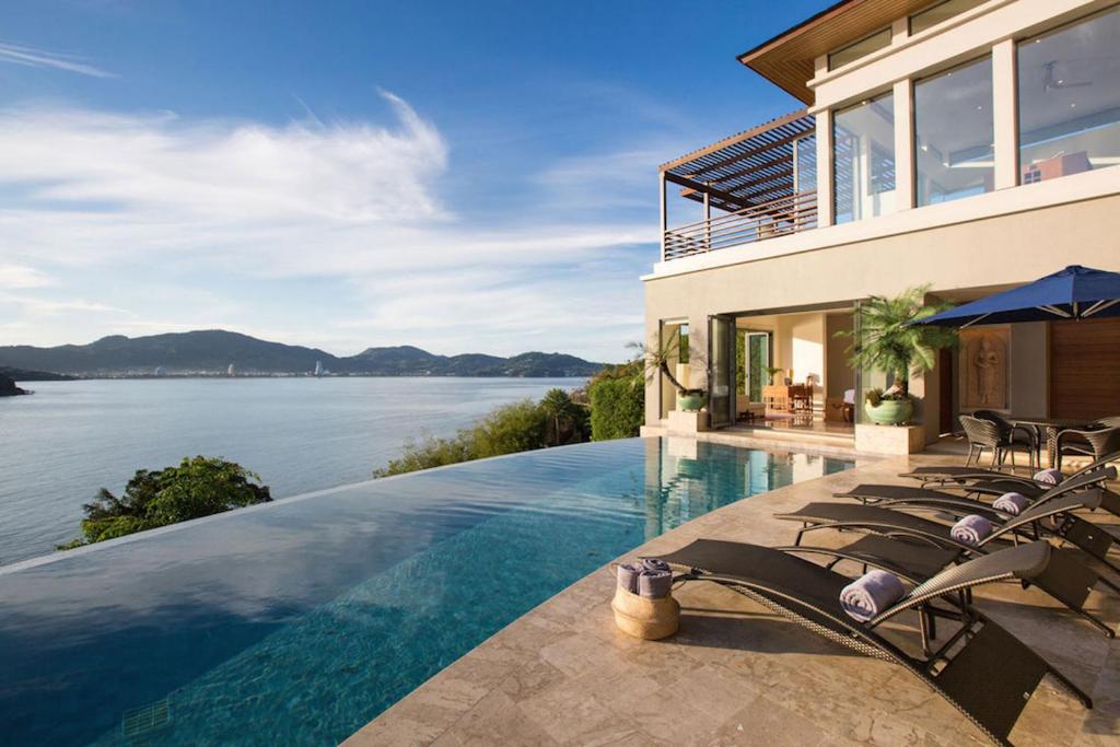 a house with a swimming pool with a view of the water at Villa Boka in Lapčići