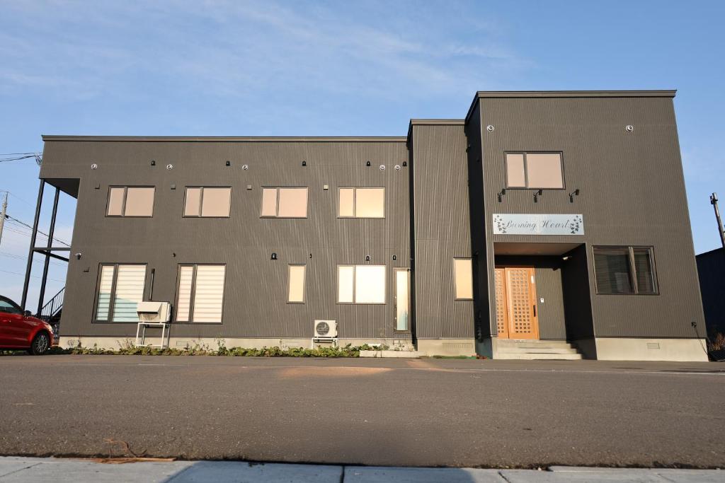 a building with a basketball hoop in front of it at バーニングハーツ in Asahikawa