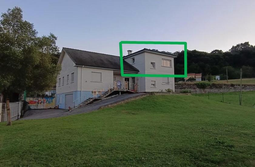 a large white house with a green frame around it at MariaS Vacation Rental in Obregón