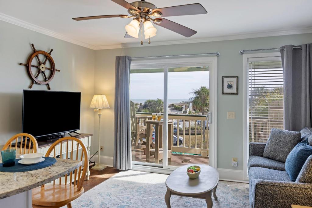 a living room with a flat screen tv and a couch at SC217A: 217A Sea Cabin in Isle of Palms
